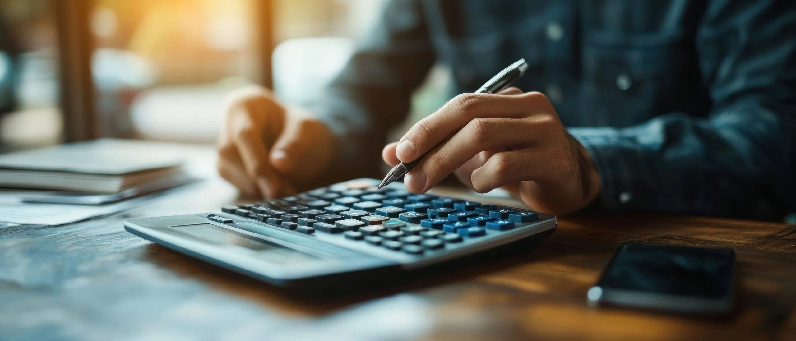 Network Charging Compensation Scheme man with pen types on calculator