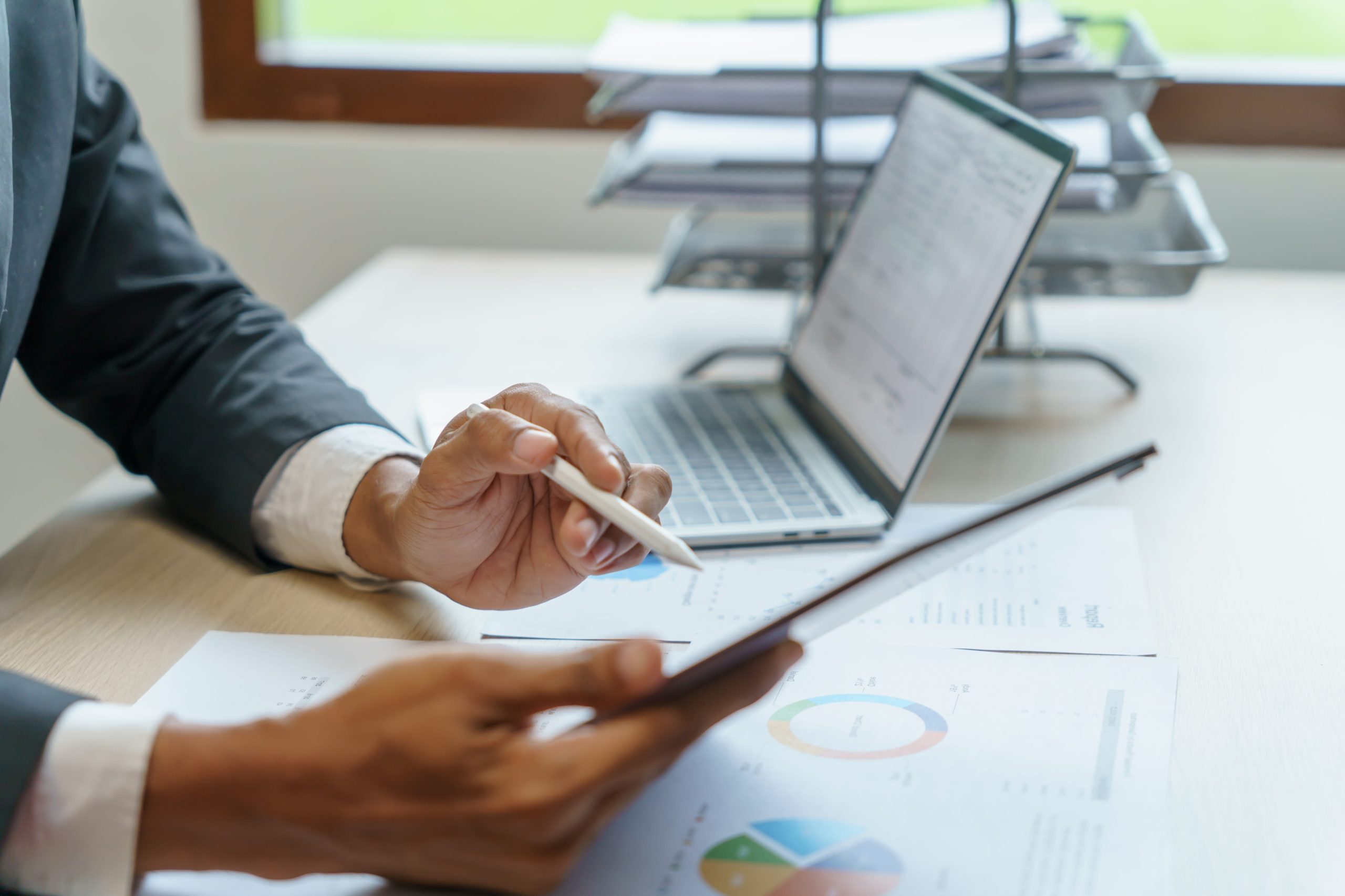 Businessman looking at laptop considering business energy contract